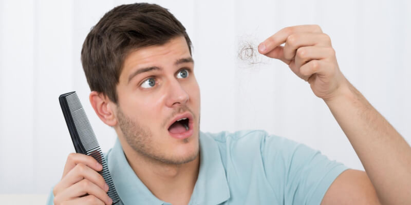 a person holding a comb and hair
