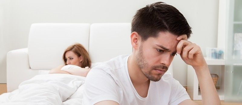a man looking at a woman in bed
