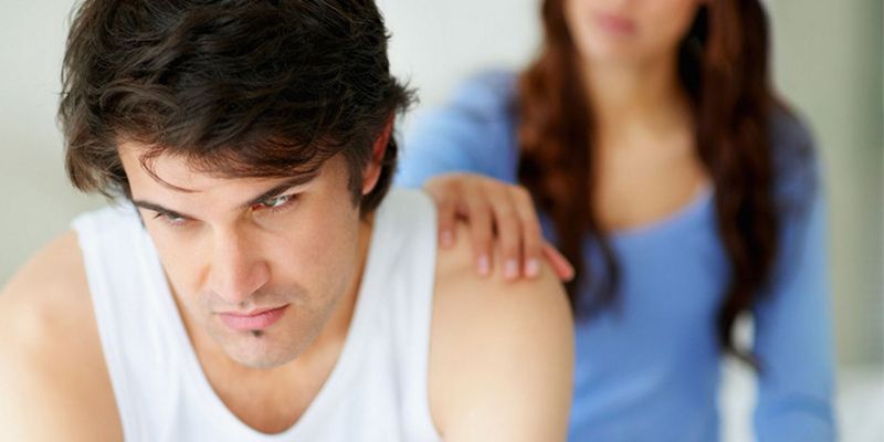 a man with a hand on his shoulder