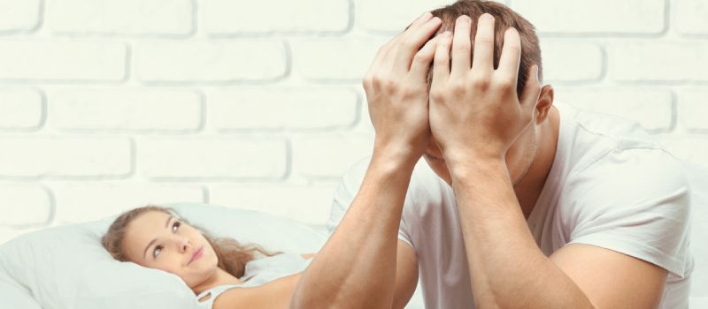 a man holding his hands to his face