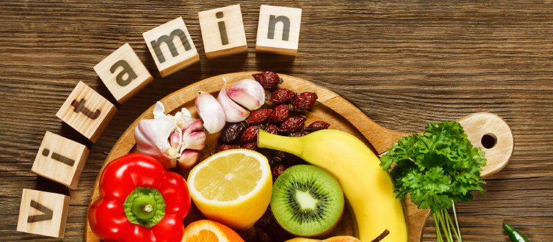 a group of fruits and vegetables on a wooden board