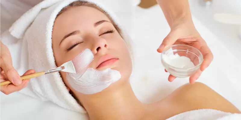 a woman with white cream on her face for skin whitening