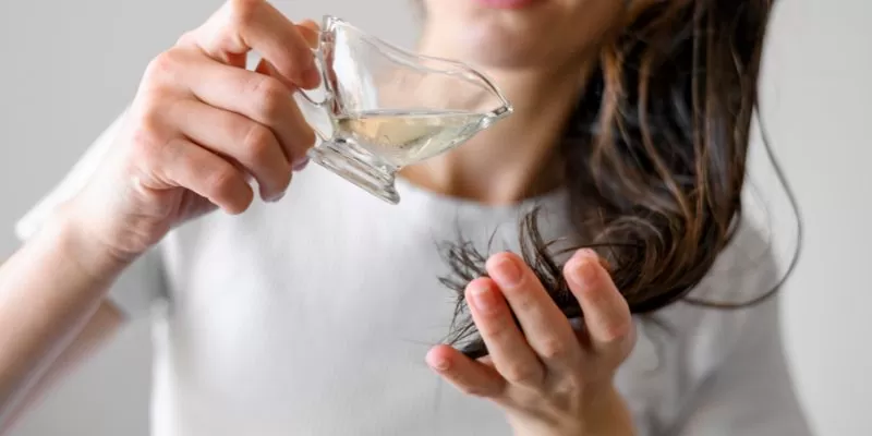 a person holding a glass of hair