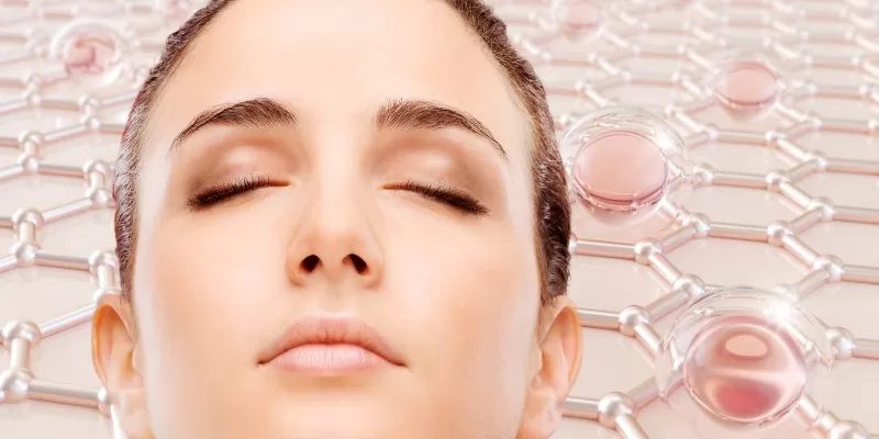 A woman with closed eyes against a pink background, symbolizing tranquility and the benefits of collagen for radiant skin.