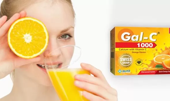 A woman proudly displays a box of gal-c 1000 in her hands, showcasing the product's features, branding, and benefits of vitamin c sachets pack.